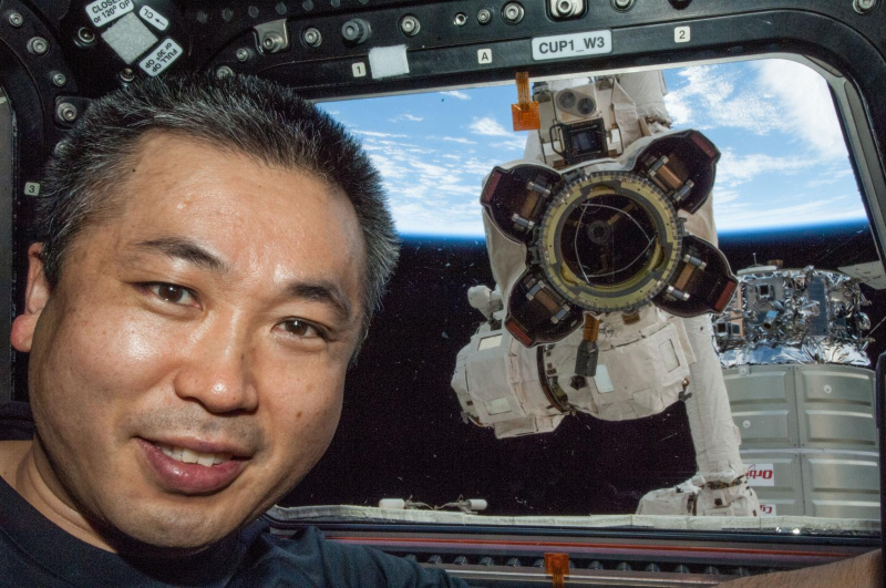 Illustration for article titled An Astronaut And His Robot Companion Are Photobombed By A Watery Planet